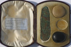Image of razor-knife and 2 of 3 polished pebbles 